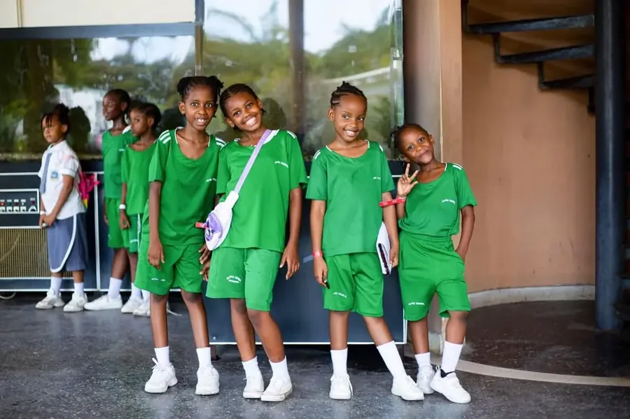 Young Alpha primary students in green sports kit